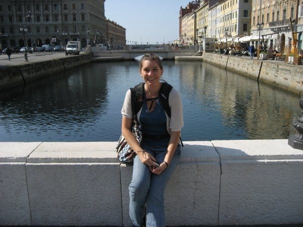 woman sitting in front of a canal in Trieste