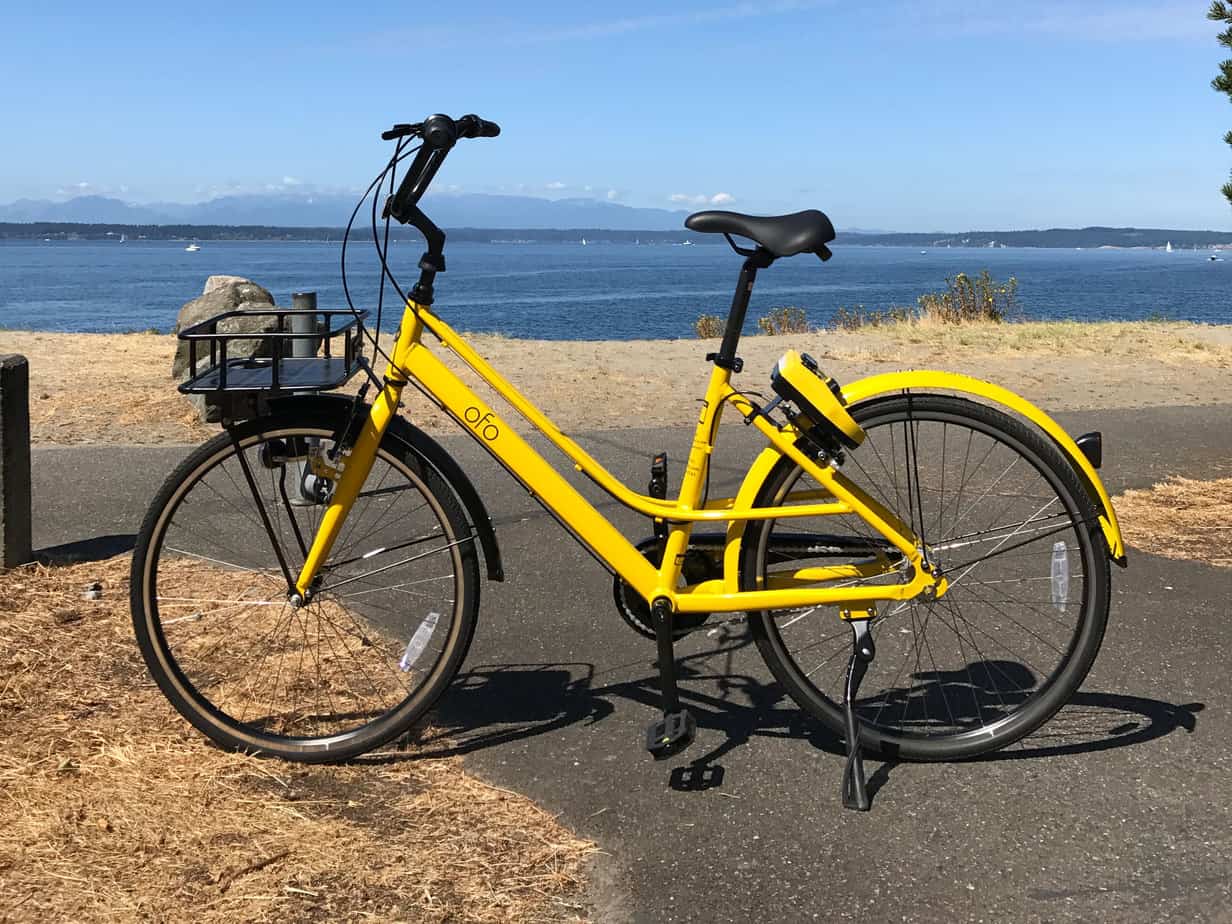 yellow bike parked in front of a beach