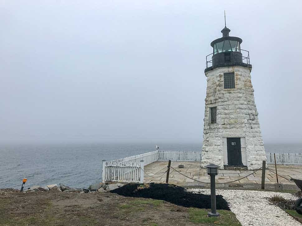 white brick lighthouse in the fog